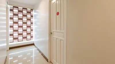 a hallway with a white door and a window at RedDoorz near Bambang Station in Manila