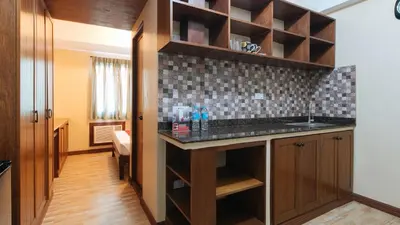 a kitchen with a sink and a counter top at RedDoorz at Moonwalk Paranaque in Manila