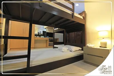 a bedroom with two bunk beds in a room at BSA Twin Towers in Manila