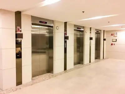 a row of elevator doors in a building at Affordable condotel near Manila Airport in Manila