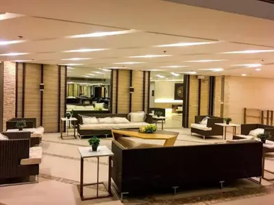 a large living room with couches and tables and chairs at Affordable condotel near Manila Airport in Manila