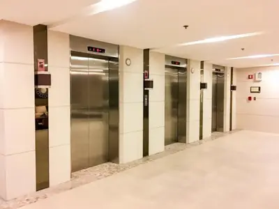 a row of elevators in a hallway in a building at Affordable condotel near Manila Airport in Manila