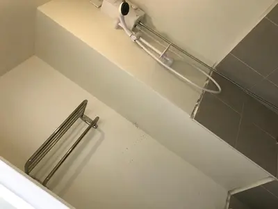 a bathroom with a towel rack and a toilet at Shanilyn Residency Urban Deca Towers EDSA mandaluyong UNLIMITED INTERNET AND NETFLIX in Manila