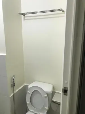 a bathroom with a white toilet in a room at Shanilyn Residency Urban Deca Towers EDSA mandaluyong UNLIMITED INTERNET AND NETFLIX in Manila