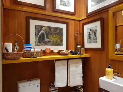 a bathroom with a sink and a counter with towels at Stay Amare Green La Salle Taft in Manila