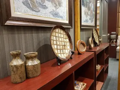 a group of vases sitting on a wooden shelf at Stay Amare Green La Salle Taft in Manila