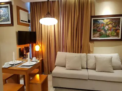 a living room with a couch and a table at Stay Amare Residences Malate in Manila