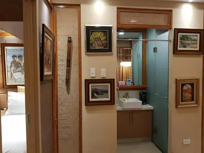 a bathroom with a sink and a mirror at Stay Amare Residences Malate in Manila