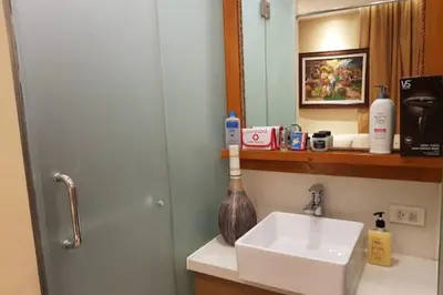 a bathroom with a sink and a mirror at Stay Amare Residences Malate in Manila