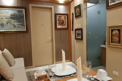 a living room with a table with a candle on it at Stay Amare Residences Malate in Manila