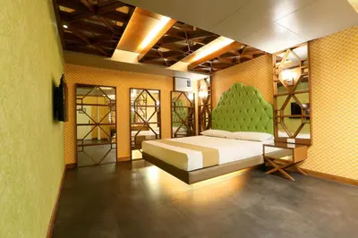 a bedroom with a bed and a yellow wall at Hotel Ava Cuneta in Manila