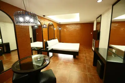 a living room with a white couch and a table at Hotel Ava Cuneta in Manila