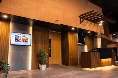 a lobby with a large screen in a building at Hotel Ava Cuneta in Manila