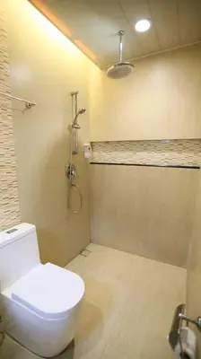 a bathroom with a toilet and a shower at Hotel Ava Gil Puyat in Manila