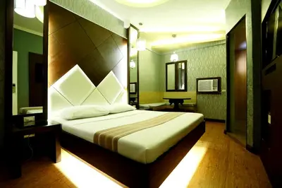 a bedroom with a large bed in a room at Hotel Ava Gil Puyat in Manila