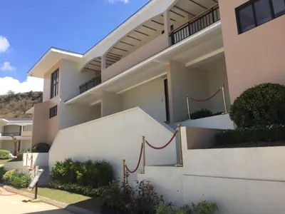 a white house with red rope on the side of it at Thunderbird Resorts - Rizal in Binangonan