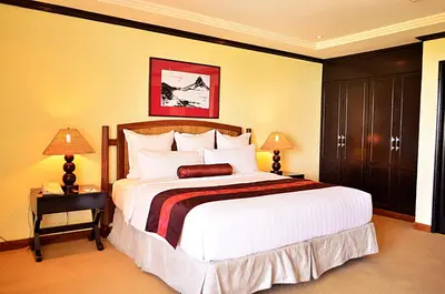 a bedroom with a large bed and two lamps at Thunderbird Resorts - Rizal in Binangonan
