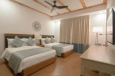a hotel room with two beds and a ceiling fan at Thunderbird Resorts - Rizal in Binangonan