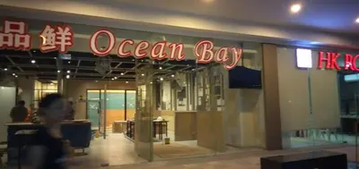 a person walking in front of an ocean bay store at Shore Residences MOA in Manila
