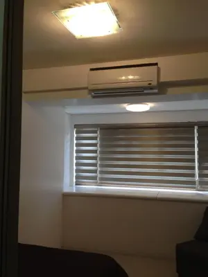 a window with a heater and a window blind at Shore Residences MOA in Manila