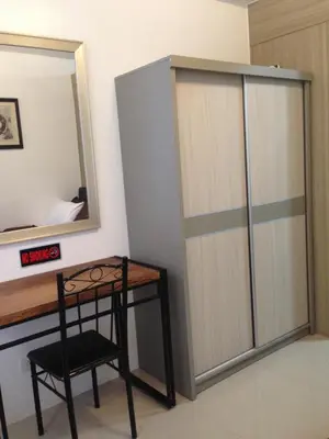 a closet with a desk and a chair next to a mirror at Shore Residences MOA in Manila