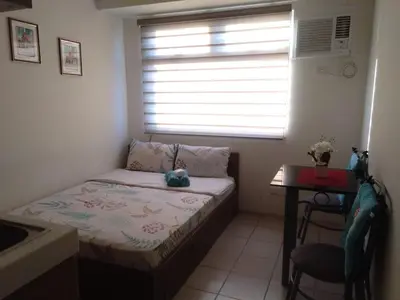 a small bedroom with a bed and a window at Superb Edsa Cheap Hotel @ Graceysplace Unit 2 in Manila
