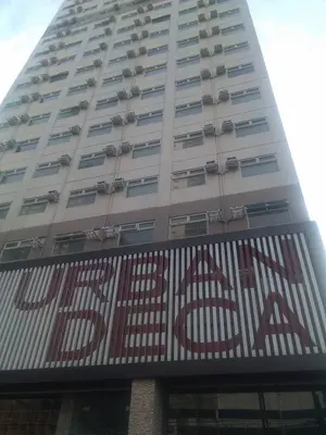 a tall building with a sign in front of it at Superb Edsa Cheap Hotel @ Graceysplace Unit 2 in Manila