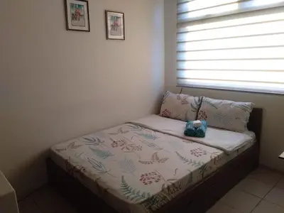 a small bed in a room with a window at Superb Edsa Cheap Hotel @ Graceysplace Unit 2 in Manila