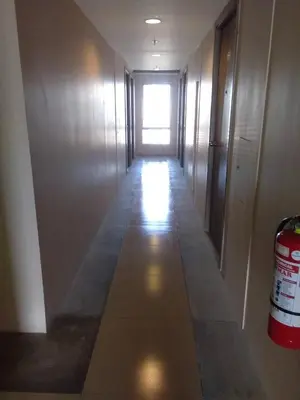 a hallway in a building with a light coming through a window at Superb Edsa Cheap Hotel @ Graceysplace Unit 2 in Manila