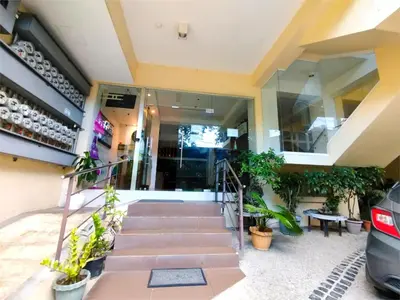 a house with stairs and plants in front of it at Sulit Budget Hotel VMapa in Manila