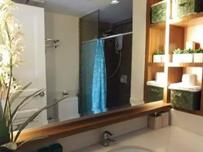 a bathroom with a shower with a mirror and a sink at Sta.Mesa across SM Model Unit 2 BR in Manila