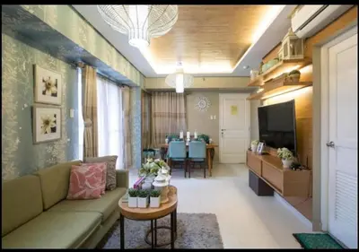 a living room with a couch and a table at Sta.Mesa across SM Model Unit 2 BR in Manila