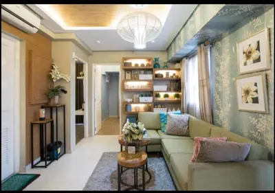 a living room with a couch and a table at Sta.Mesa across SM Model Unit 2 BR in Manila
