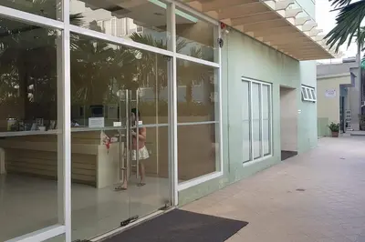 a woman standing in a glass door of a building at Condotel Type in Manila