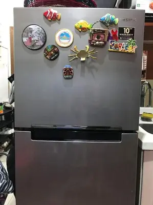 a refrigerator with a bunch of magnets on it at Condotel Type in Manila