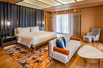 a hotel room with a bed and a couch at Hotel Okura Manila at Newport World Resorts in Manila
