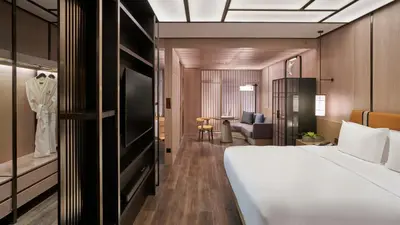 a hotel room with a bed and a table at Hotel Okura Manila at Newport World Resorts in Manila