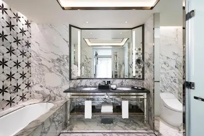 a bathroom with a tub and a sink and a mirror at Hotel Okura Manila at Newport World Resorts in Manila