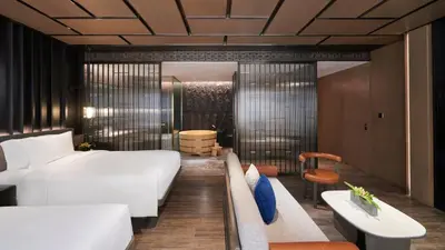 a hotel room with a bed and a couch at Hotel Okura Manila at Newport World Resorts in Manila