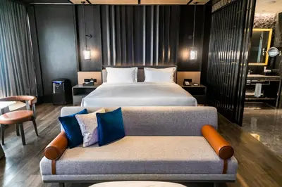 a hotel room with a bed and a couch at Hotel Okura Manila at Newport World Resorts in Manila