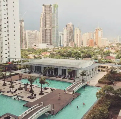a large pool of blue water in a city at Condotel @JAZZ Residences in Manila