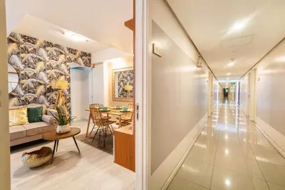 a living room with a couch and a table at Adam'sCrib Apartment 2BR by Azure Residences Near Manila International Airport in Manila
