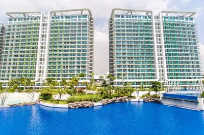 a view of two tall buildings with a pool in front at Adam'sCrib Apartment 2BR by Azure Residences Near Manila International Airport in Manila