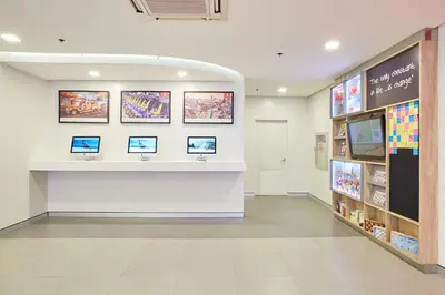 a lobby of a store with computers on the wall at Red Planet Makati Avenue Manila in Manila