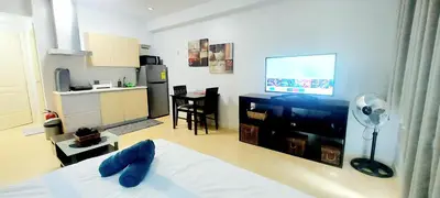a living room with a bed and a kitchen at N place at Soho Central in Manila