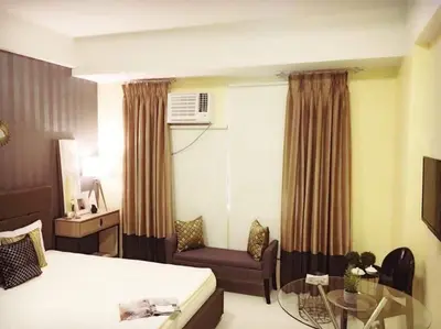 a hotel room with a bed and a couch and a table at 101 Newport City near NAIA 3, Pasay City in Manila