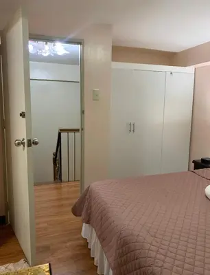 a bedroom with a bed and a sliding glass door at Affordable 2 BR 2 BA w/ Skycable, Netflix, & Amazon Prime in Manila