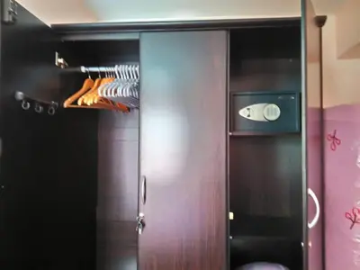 a closet with a wooden door and a shelf at Affordable 2 BR 2 BA w/ Skycable, Netflix, & Amazon Prime in Manila