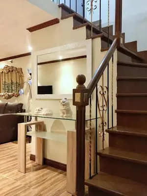 a staircase with a glass table in a living room at Affordable 2 BR 2 BA w/ Skycable, Netflix, & Amazon Prime in Manila