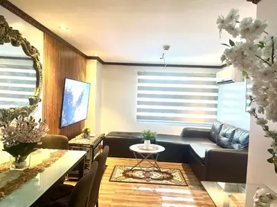 a living room with a couch and a table at Affordable 2 BR 2 BA w/ Skycable, Netflix, & Amazon Prime in Manila